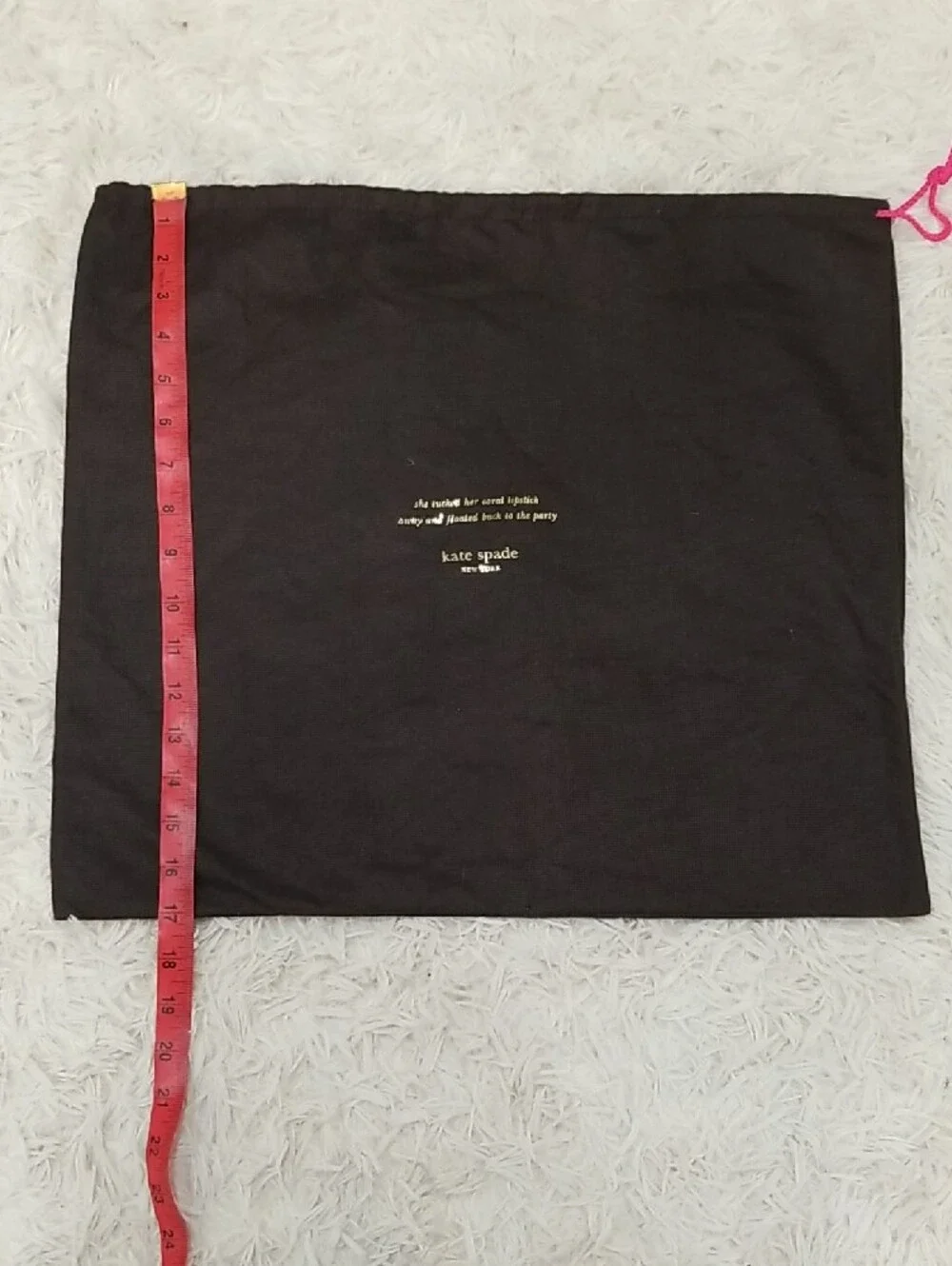 kate spade black dust bag with pink drawstring and gold logo